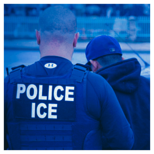 Immigration/Border: A photo of an Immigration Control Enforcment Officer detaining an individual