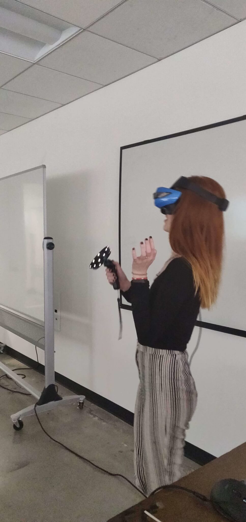 Surprised woman wearing VR headset  looking at VR for first time.